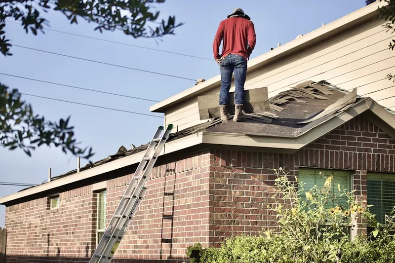 Professional roofer working on a residential roof in Long Point Park